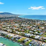 Aerial view of a Melbourne suburb showcasing houses for sale, highlighting the residential layout and green spaces.
